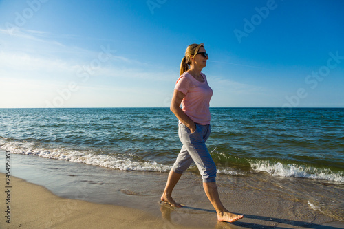 Woman waking on beach
