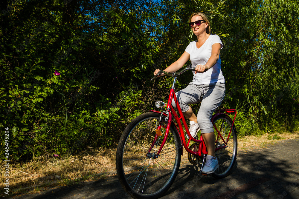 Healthy lifestyle - middle-aged woman riding bicycles