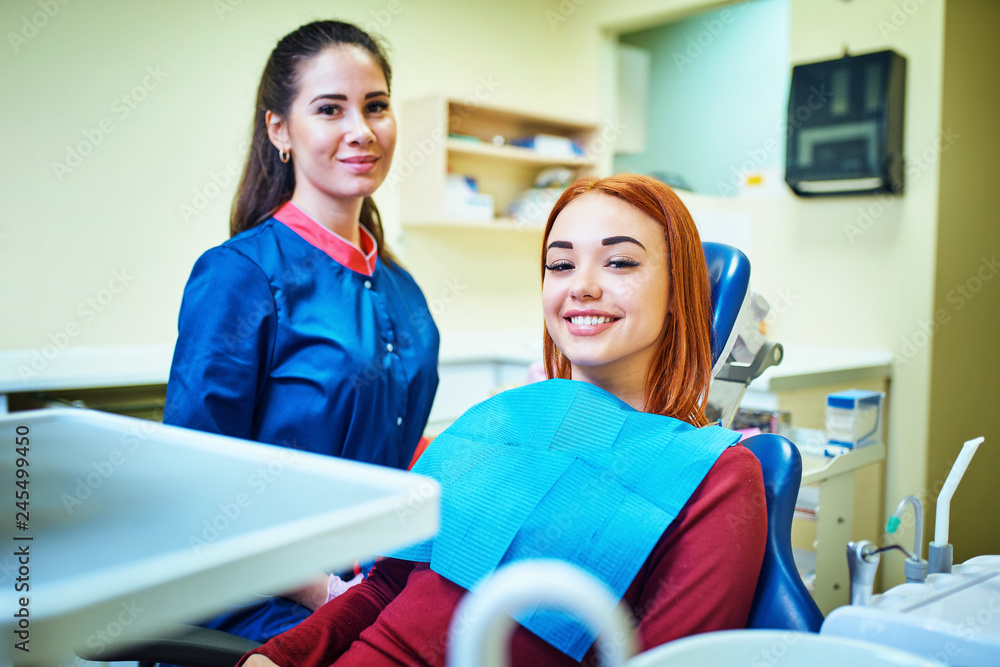 Dentist examining a patient's teeth in the dentist Dentist examining a patient's teeth in the dentist