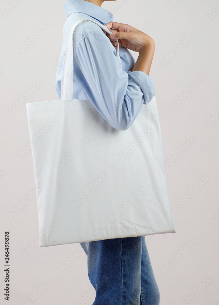 woman holding eco fabric bag isolate on gray background woman holding eco fabric bag isolate on gray background