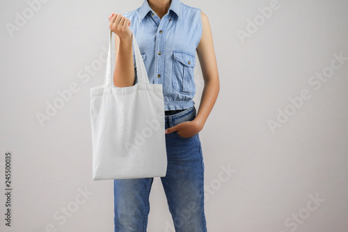 woman holding eco fabric bag isolate on gray background
