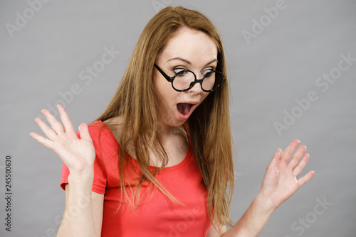 Shocked woman wearing nerd glasses