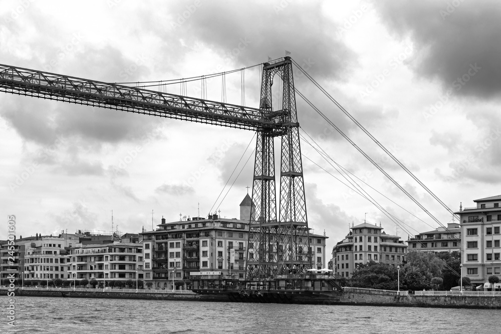 the suspension bridge of bizkaia (puente de vizcaya) between getxo and portugalete over the ria de bilbao, black and white