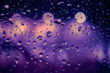 Abstract circular bokeh background of night light with raindrops