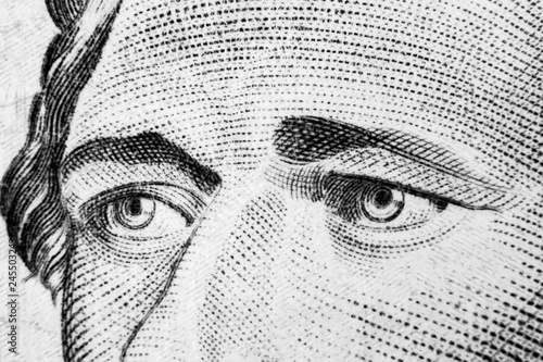 Close up view Portrait of Alexander Hamilton on the one ten dollar bill. 10 dollar bill with Alexander Hamilton eyes macro shot. Money background. Face portrait. Black and white