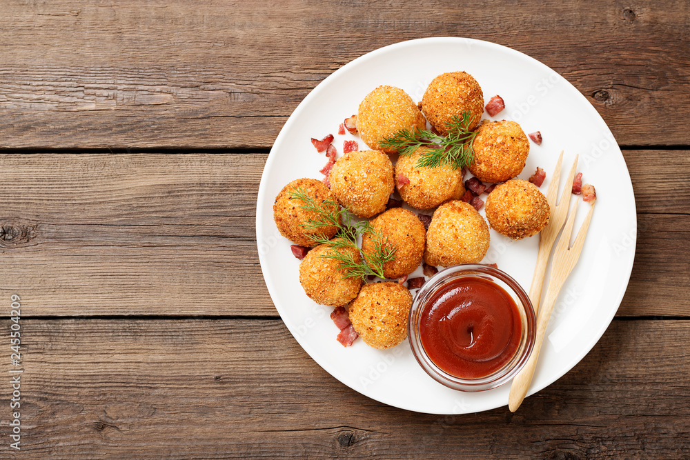 Potato croquettes - mashed potatoes balls breaded and deep fried, served with different sauce. Potato croquettes - mashed potatoes balls breaded and deep fried, served with different sauce.