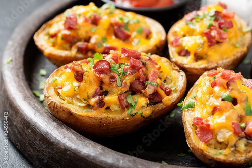 Canvas Print Hot baked potato topped with bacon, green onions and cheddar cheese