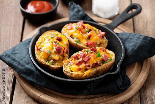 Hot baked potato topped with bacon, green onions and cheddar cheese.