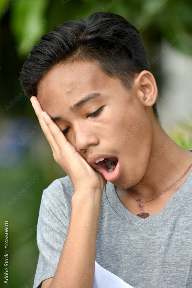 Yawning Youthful Filipino Teenager Boy