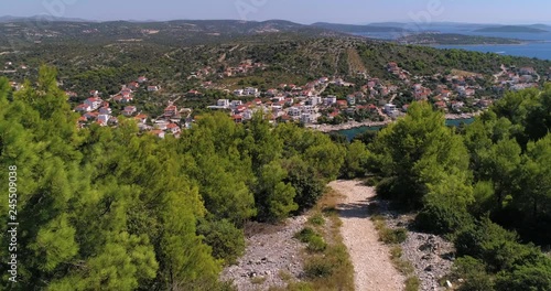Wallpaper Mural Mediterranean town, C4k aerial, reverse, drone shot, of the Razanj village on the croatian coast, over a sand road and green, bushes, on a sunny, summer day, in Croatia Torontodigital.ca