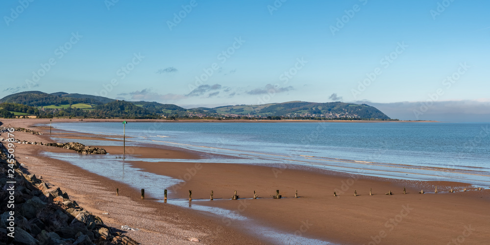 The beach in Blue Anchor, Somerset, England, UK - looking at the Bristol channel and Minehead in the background