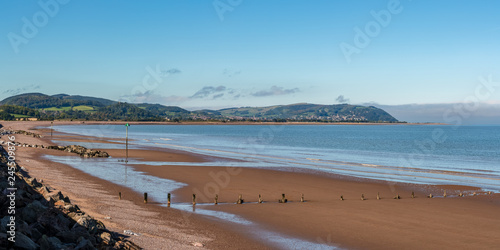 The beach in Blue Anchor, Somerset, England, UK - looking at the Bristol channel and Minehead in the background photo