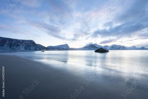 Long exposure polar night landscape of beach with mountain in the winter