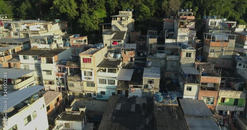 Aerial flying slowly past hilltop favela houses in Rio de Janeiro, Brazil at sunrise Aerial flying slowly past hilltop favela houses in Rio de Janeiro, Brazil at sunrise