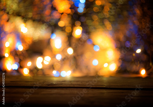   urposely defocused. Wood table top with blurred light gold blue bokeh abstract christmas background.