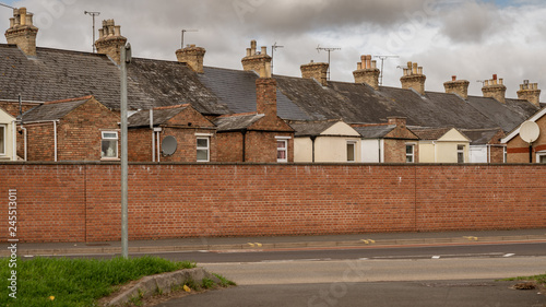 Houses behind a wall in a street in Taunton, Somerset, England, UK photo