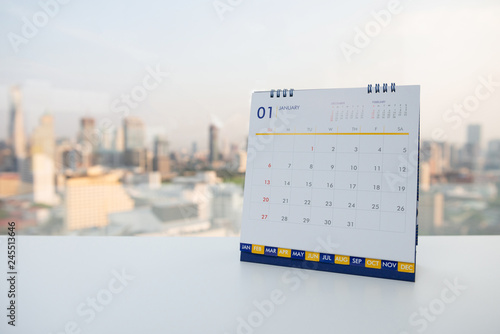 Calendar of January on the white table with city view background