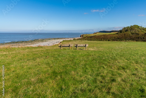Benches at Kilve Beach in Somerset, England, UK - looking over the Bristol Channel