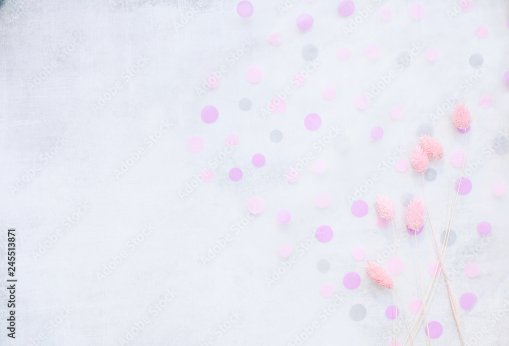 Soft light gray background with pink polka dots and pink flowers. copy space.
