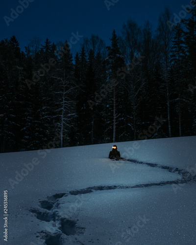 Creepy man on snowy field full moon