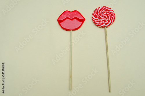 two lollipops on a beige background © Olga