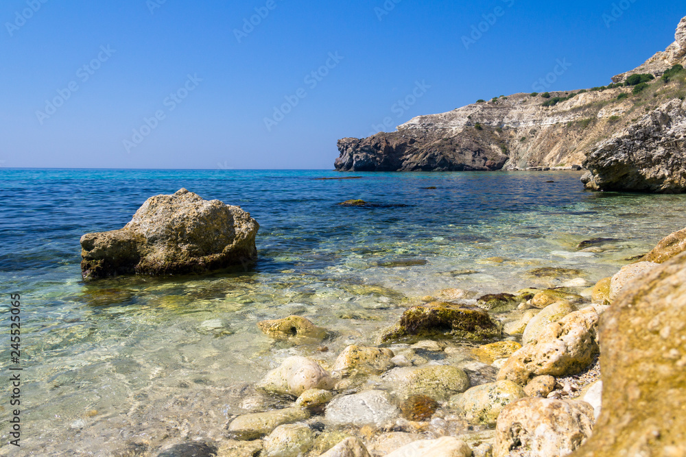 Landscape sea waves line impact rock on the beach. Stones at the beach with wave and nice blue sky. turquoise water