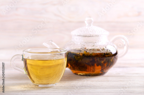 Pouring hot herbal tea in a cup