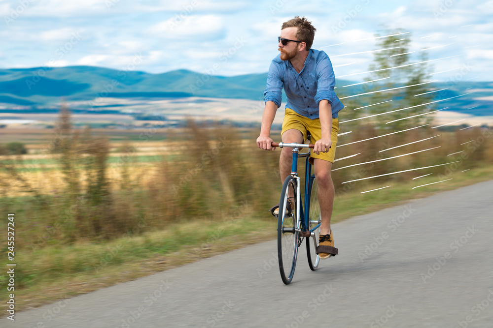 Casual hipster cyclist riding bicycle with high speed concept Casual hipster cyclist riding bicycle with high speed concept