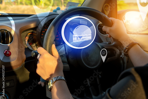 Closed up of hands driving in the car with modern virtual screen augmented reality navigation direction for destination .Futuristic car driving technology concept .