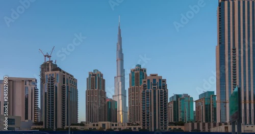 Panorama of skyscrapers and Burj Khalifa tower from day to night. Time Lapse. photo