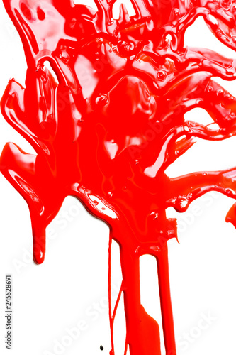 Thick red paint on a white background. Paint flows