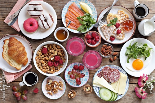 Brunch. Family breakfast or brunch set served on rustic wooden table. Overhead view