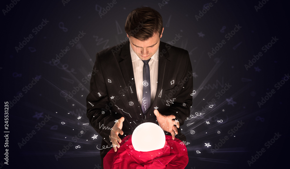 Fototapeta premium Gorgeous businessman looking to inspiration in a magic ball in his lap and doodle concept 