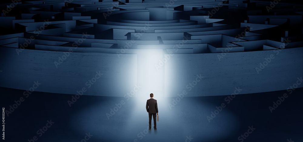 Businessman getting ready to enter a concentric labyrinth with lighted entrance concept
Businessman getting ready to enter a concentric labyrinth with lighted entrance concept