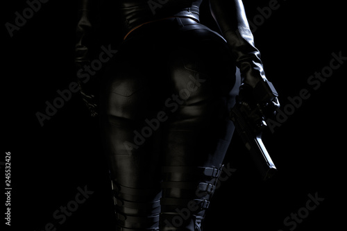 Sexy female assassin in leather suit