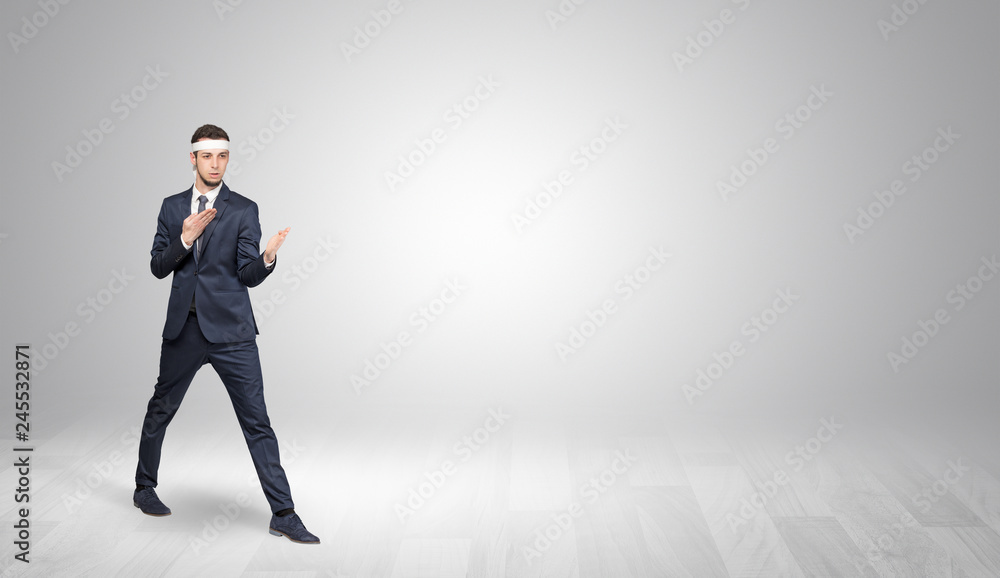 Young businessman in suit fighting in an empty space
Young businessman in suit fighting in an empty space