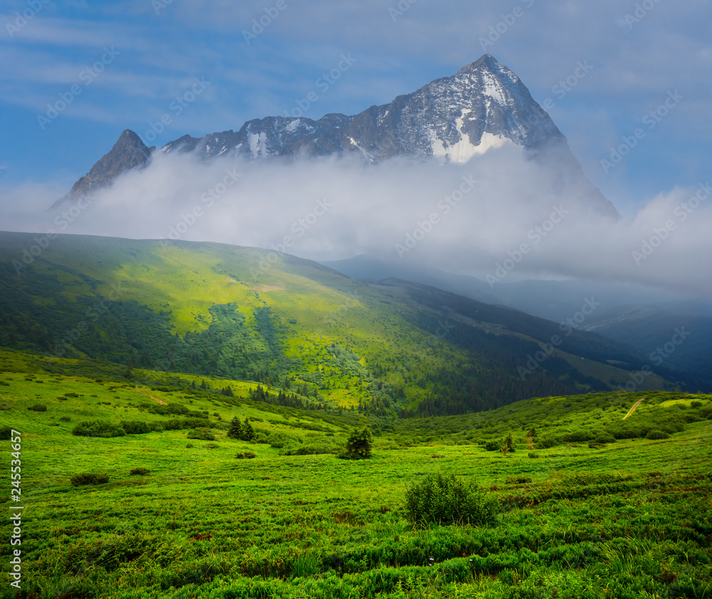 beautiful green mountain valley before the lonely mountain in a clouds, fantasy landscape