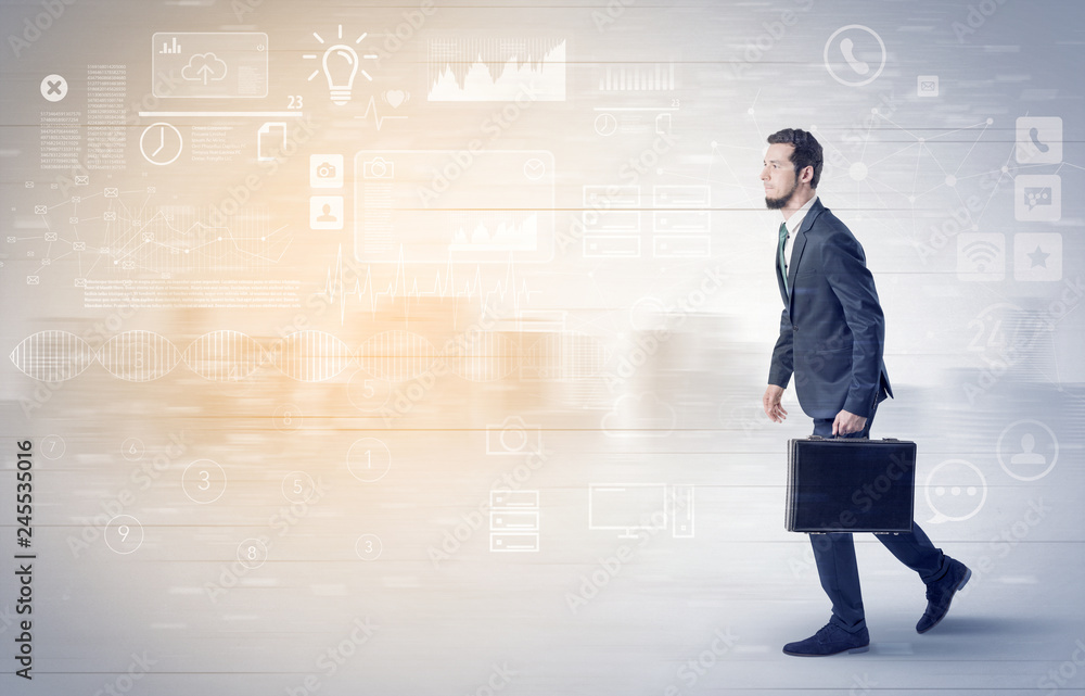 Handsome businessman walking in suit with briefcase on his hand and database concept around
Handsome businessman walking in suit with briefcase on his hand and database concept around