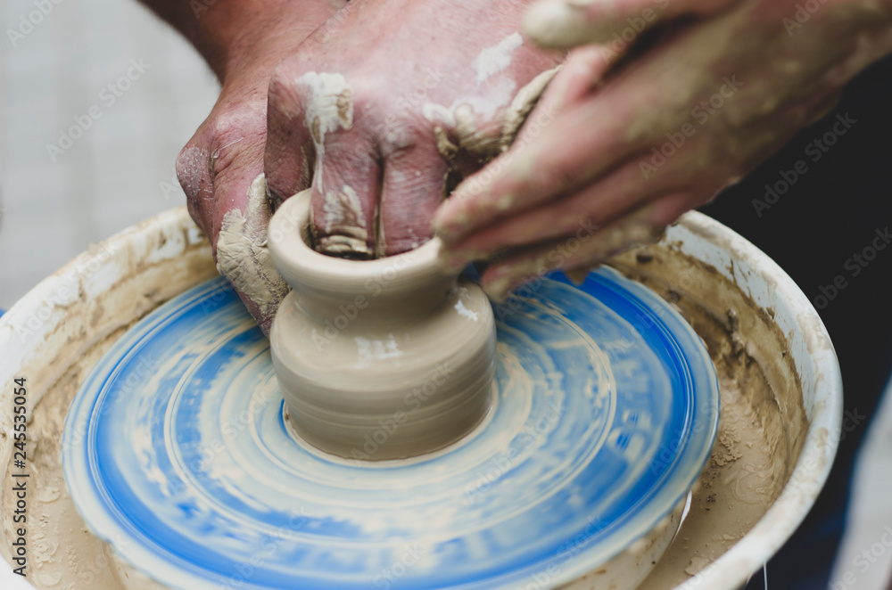 Street master class on modeling of clay on a potter's wheel In the pottery workshop Street master class on modeling of clay on a potter's wheel In the pottery workshop