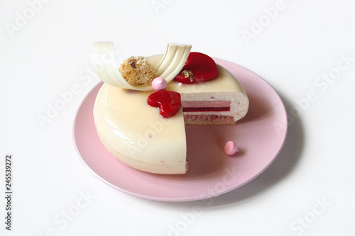 Contemporary Layered Yogurt Mousse Cake decorated with Strawberry Jelly Hearts, on white background.
