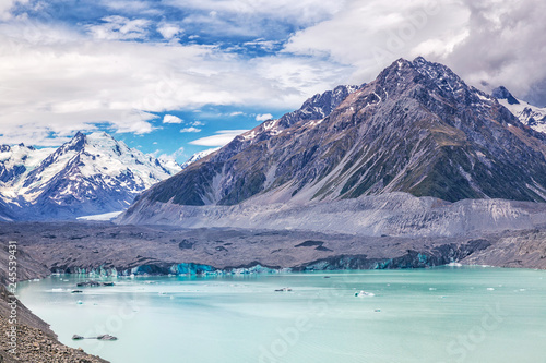 Beautiful turqouise Tasman Glacier Lake and Rocky Mountains in the clouds, Mount Cook National Park, South Island, New Zealand