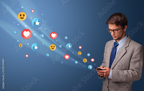 Wallpaper Mural Young person using smartphone with flying social media icons around
 Torontodigital.ca