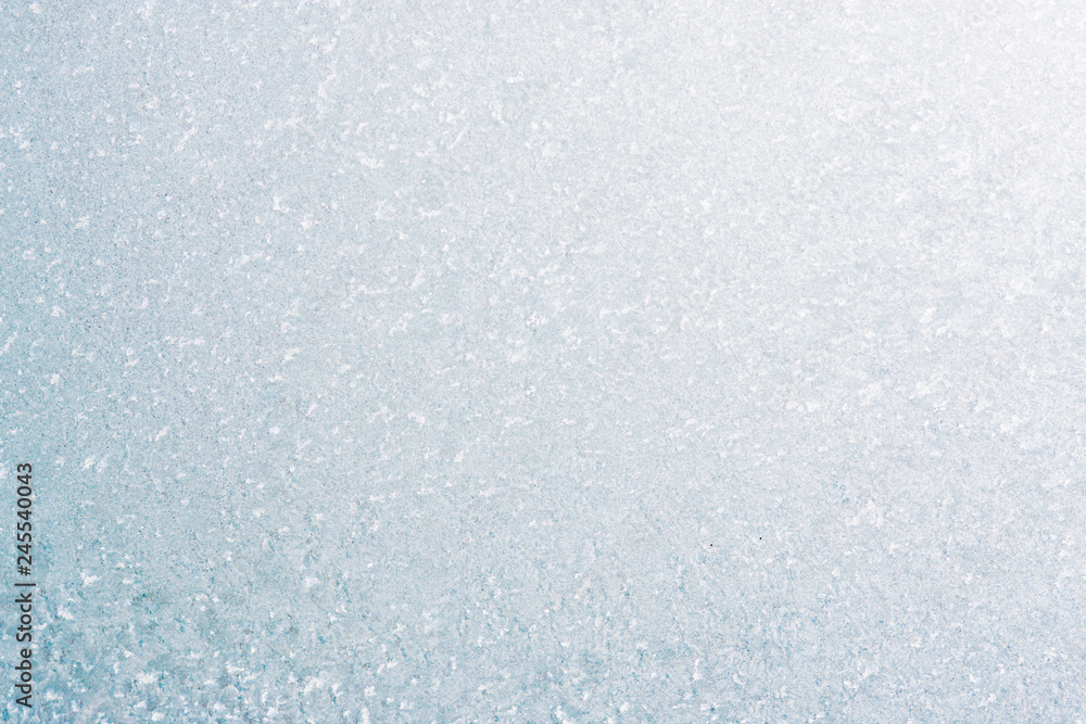 Fototapeta premium Frozen winter abstract background on the window glass with copy space