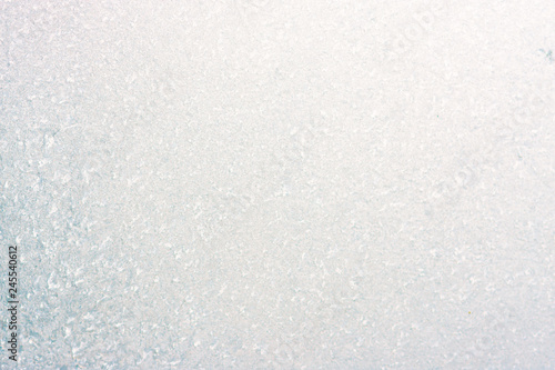 Frozen winter abstract background on the window glass with copy space