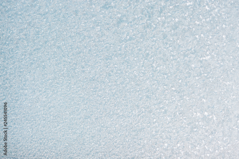 Winter background with gleaming ice. Frozen water texture. Copy space