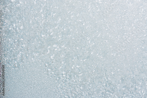 Winter background with gleaming ice. Frozen water texture. Copy space