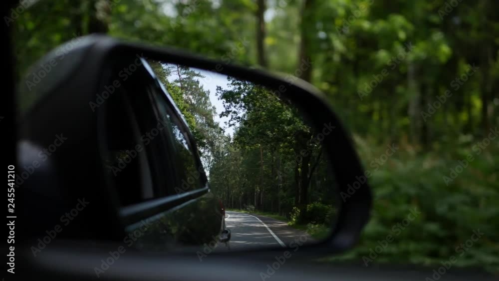 View out the rearview mirror as car drives on country road. 4K View out the rearview mirror as car drives on country road. 4K