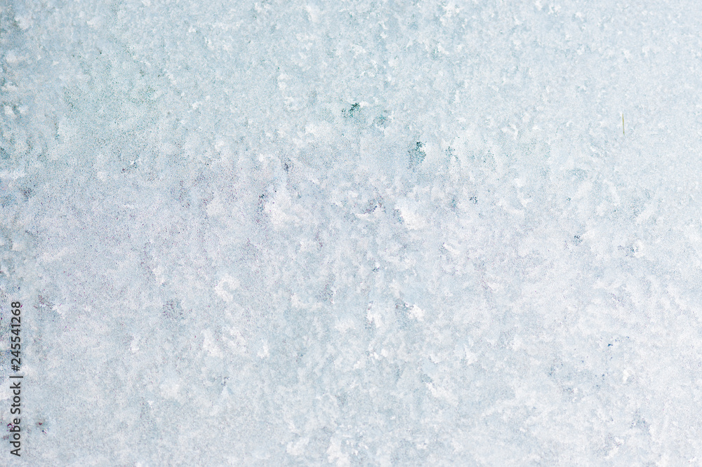 Winter background with gleaming ice. Frozen water texture. Copy space.