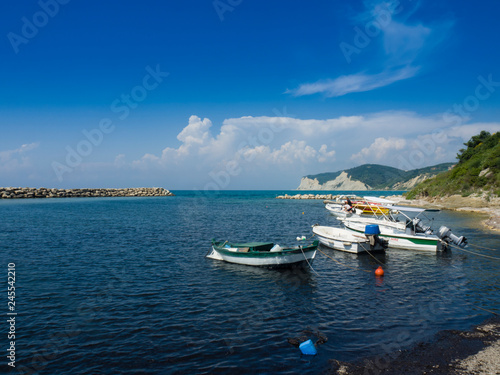Pleasure boats moored off Kassiopi beach on the Greek island of Corfu Greece.
