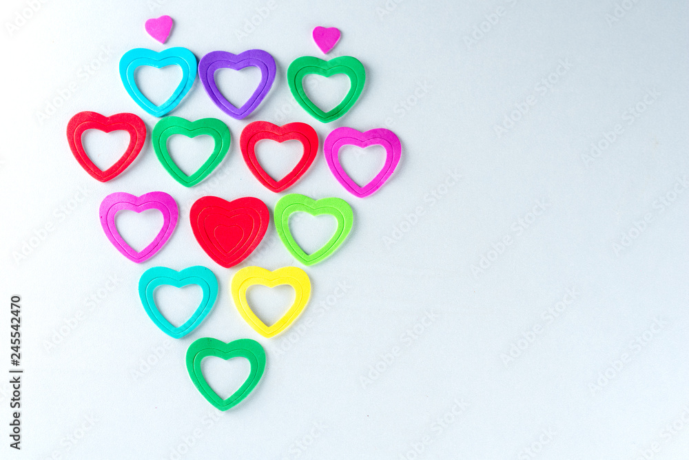 Colorful paper hearts on white background.